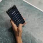 Mãos interagindo com um teclado virtual, com ícones do ChatGPT e Google Apps Script ao fundo, simbolizando a colaboração entre IA e automação.